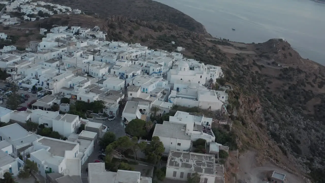 Aerial view over typically Greek Village Small Town on Island in Sunset Golden Hour Light