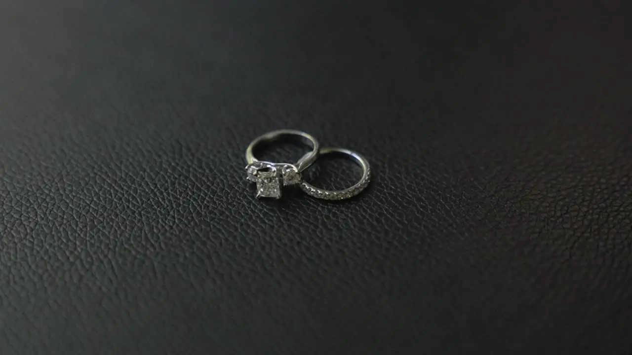 Close up slow motion shot of bride's wedding ring and engagement ring