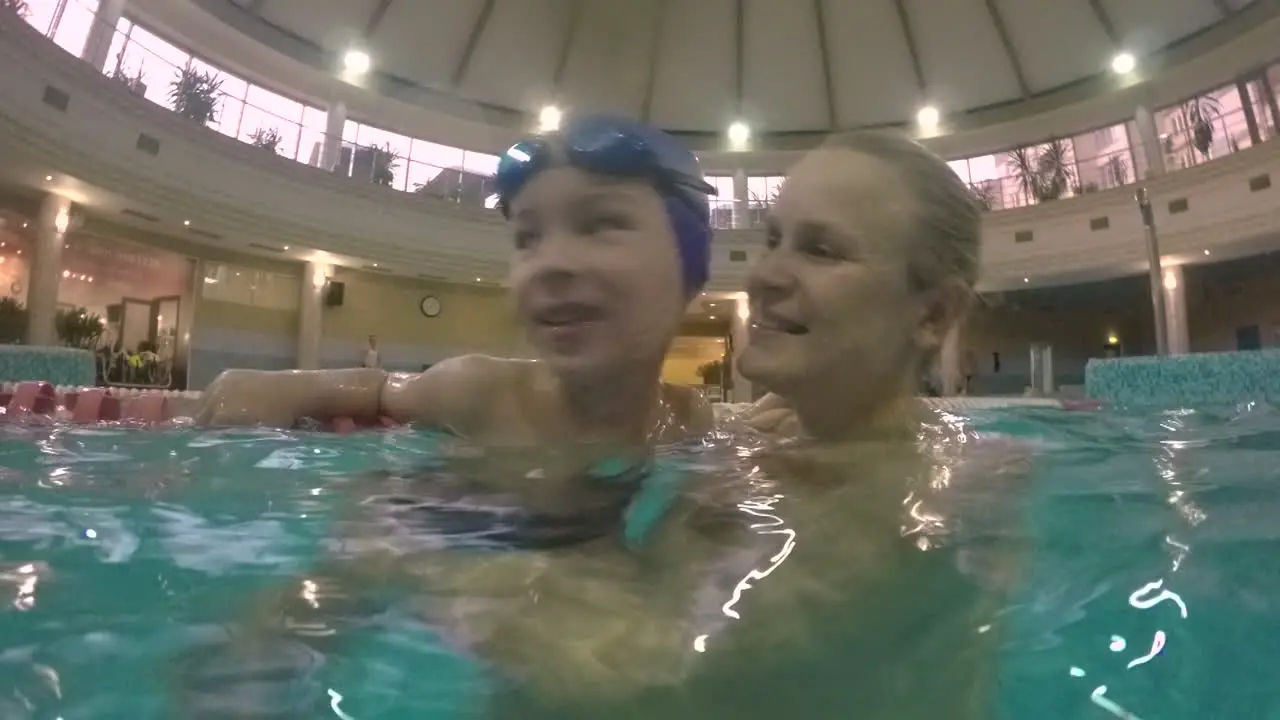 Happy and loving mother with son in the pool