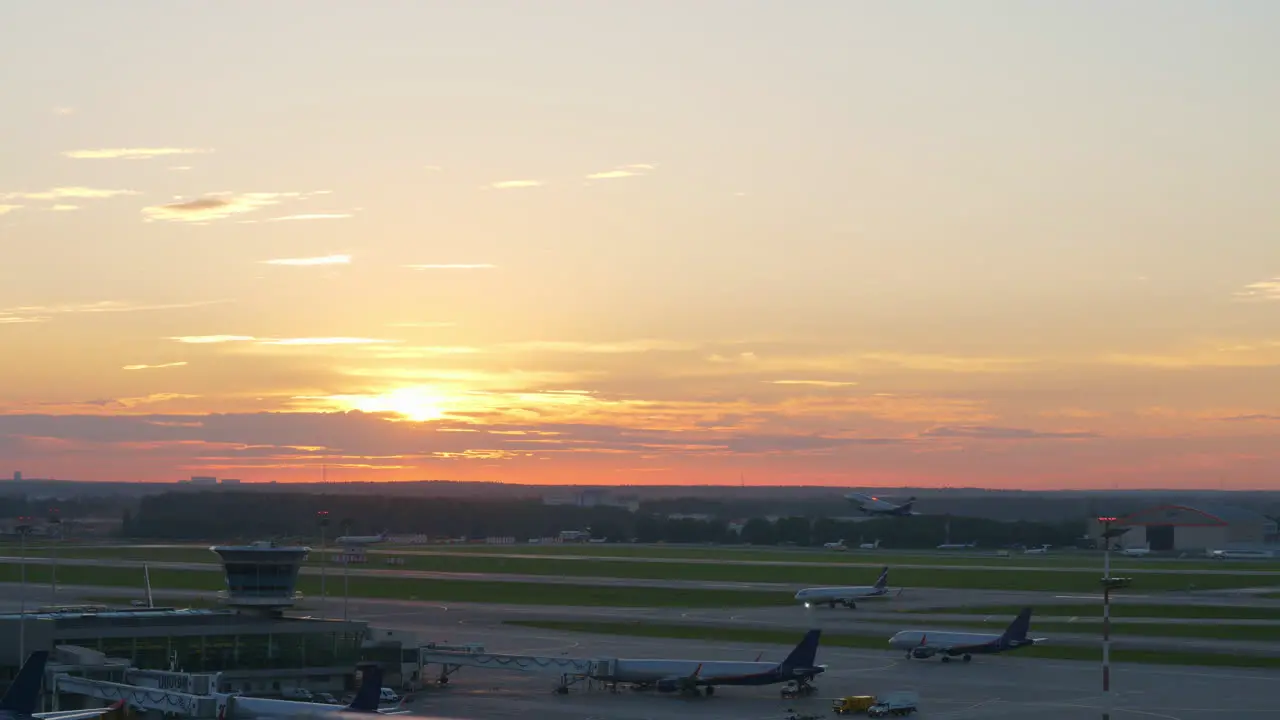 View of airport at sunset plane taking off