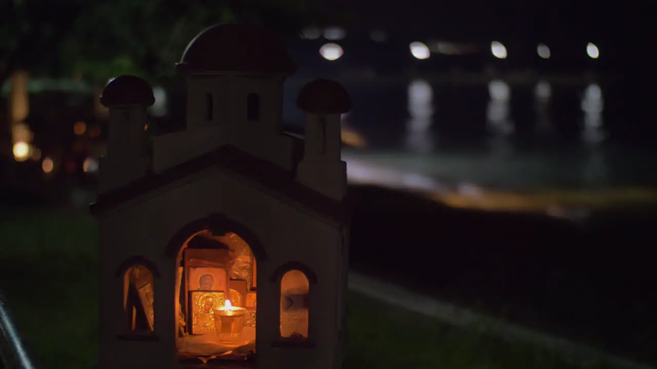 Miniature of Greek Orthodox church on sea-front at night