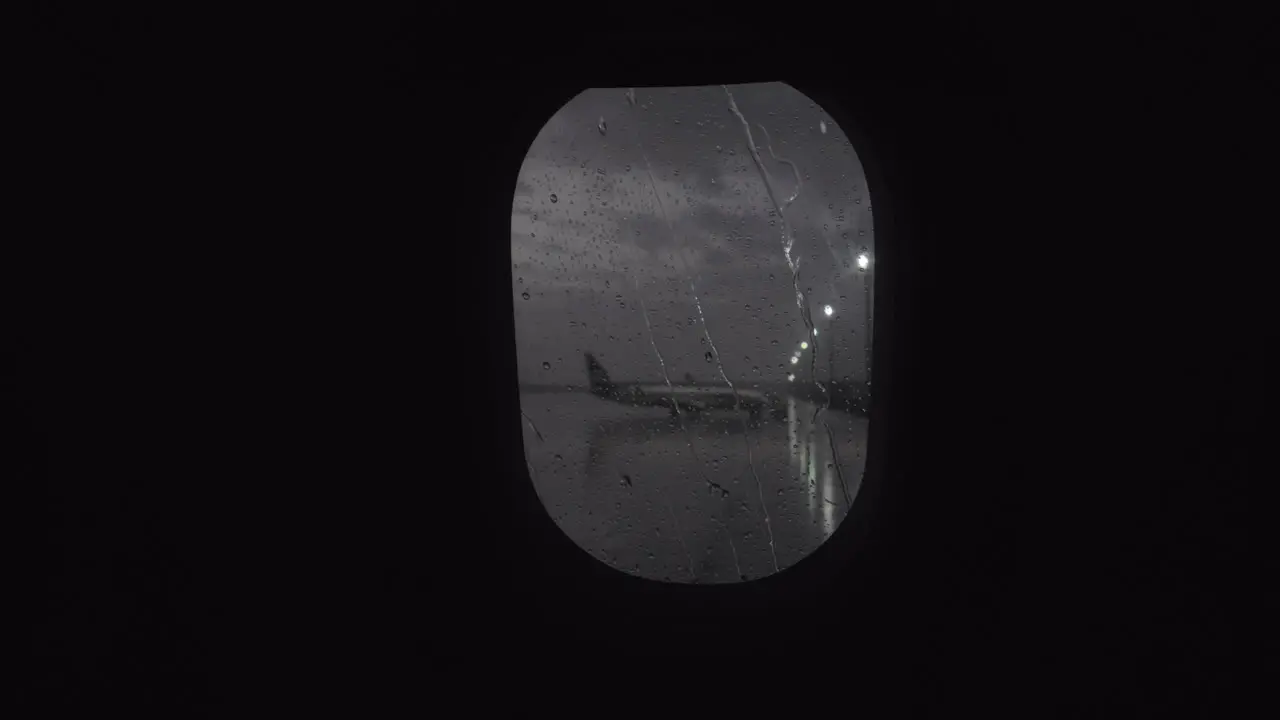 Illuminator with rain streaks view to airport from moving plane