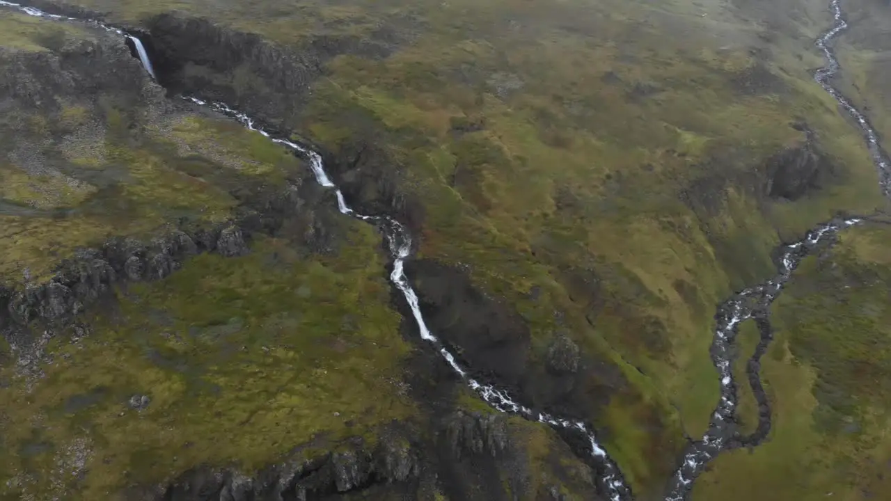 Aerial of small streams and waterfalls during foggy weather in Iceland