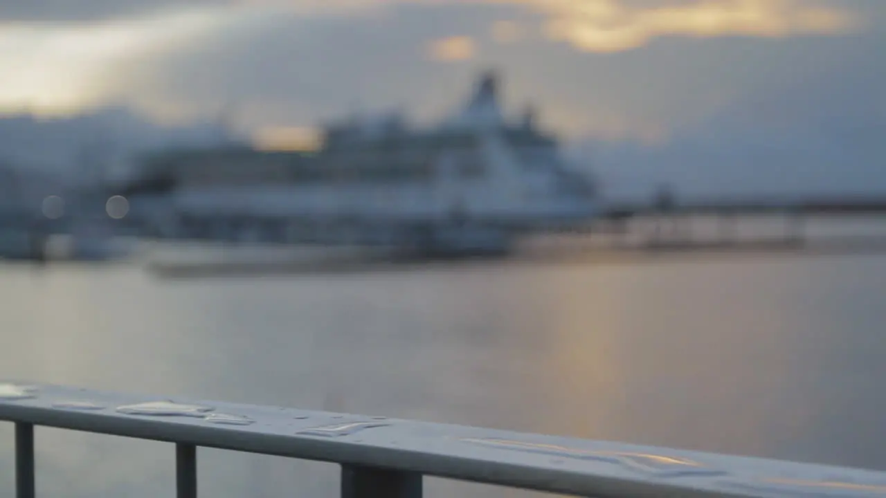 Tracking shot of a wet railing at the sea port and marina of Ponta Delgada on the island of Sao Miguel of the Portuguese Azores