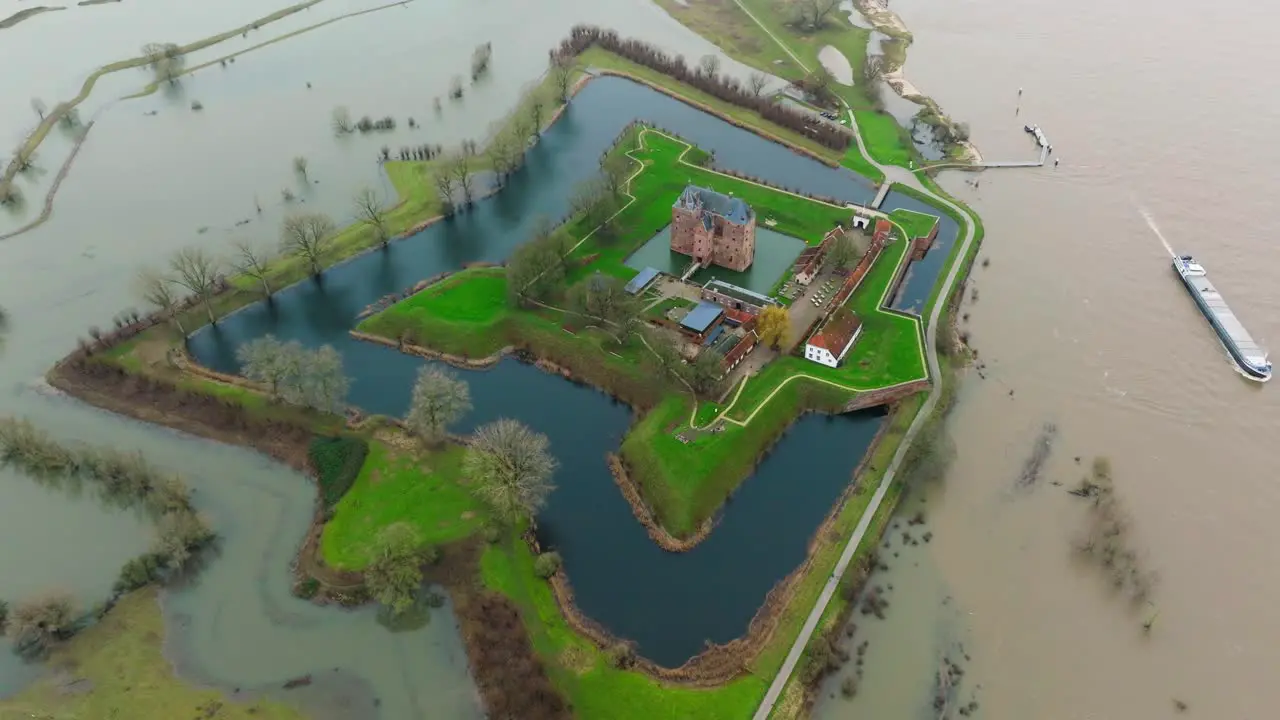 Overflown banks of river Waal caused flooding around Loevestein castle