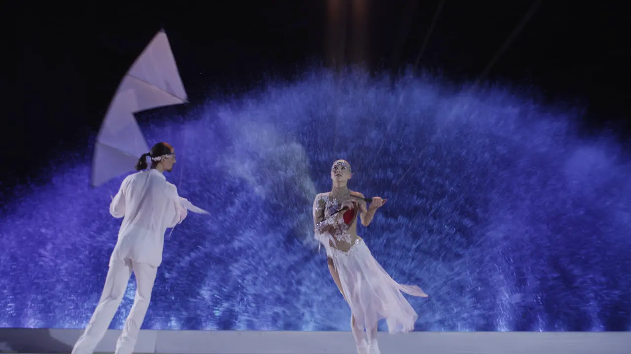 Figure skaters couple dancing on the ice with kites