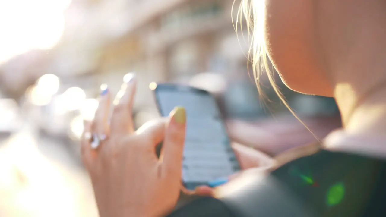 Woman in the street browsing social media on mobile