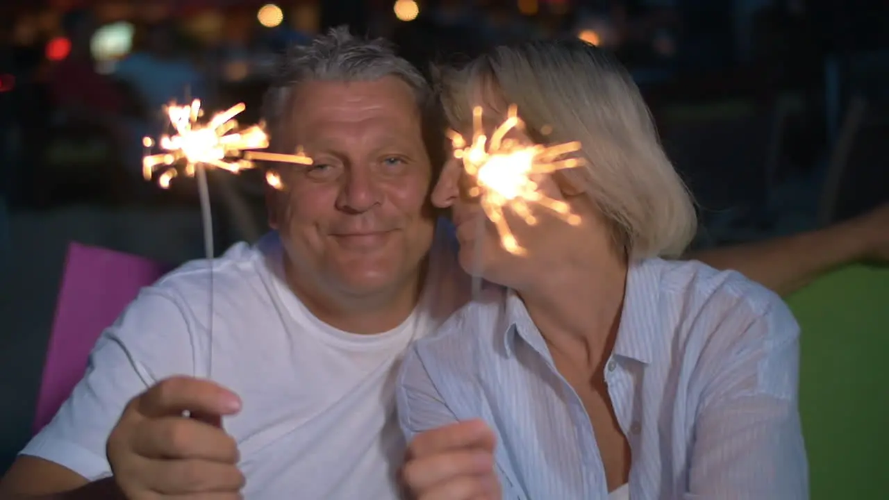 Couple with lit sparklers