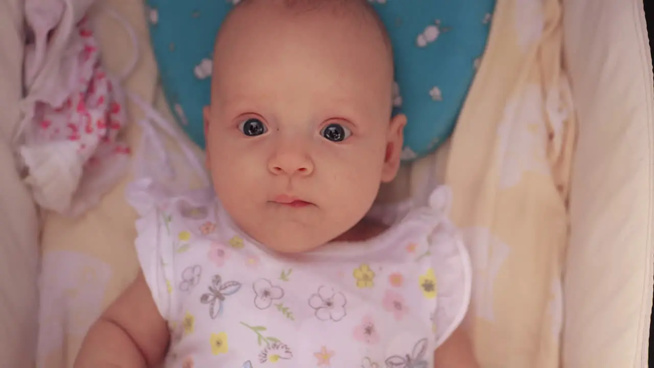 Portrait of baby girl in pram looking to the camera