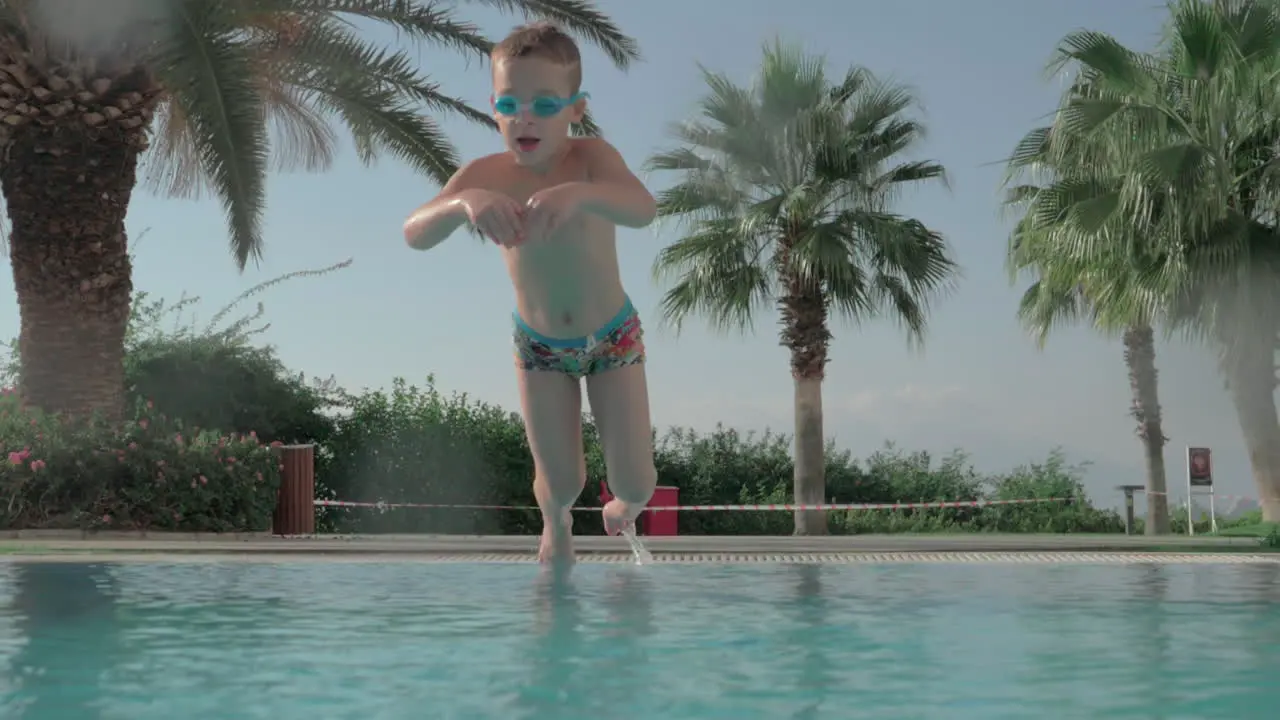 Child diving and swimming underwater in the pool