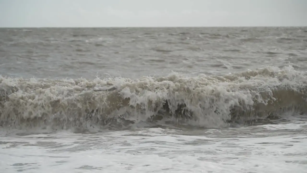 Sea waves crashing onto the beach in slow motion