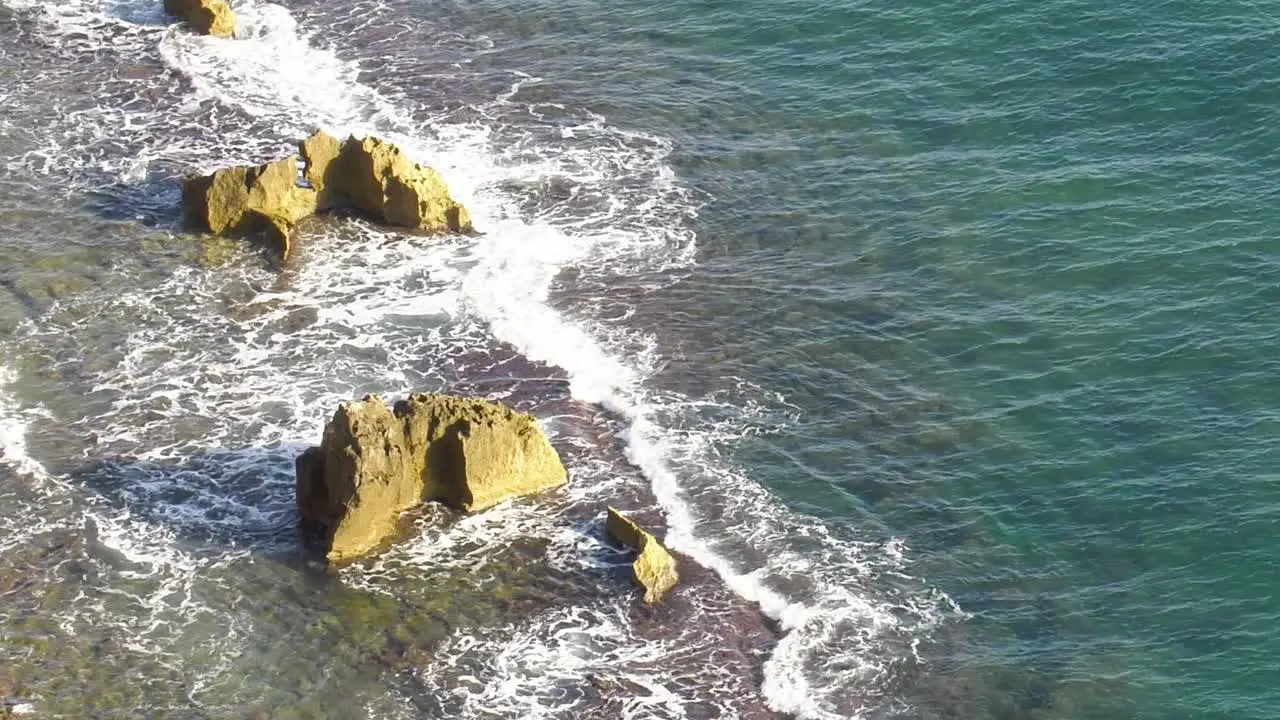 Rocky coastline with gentle waves washing over reef