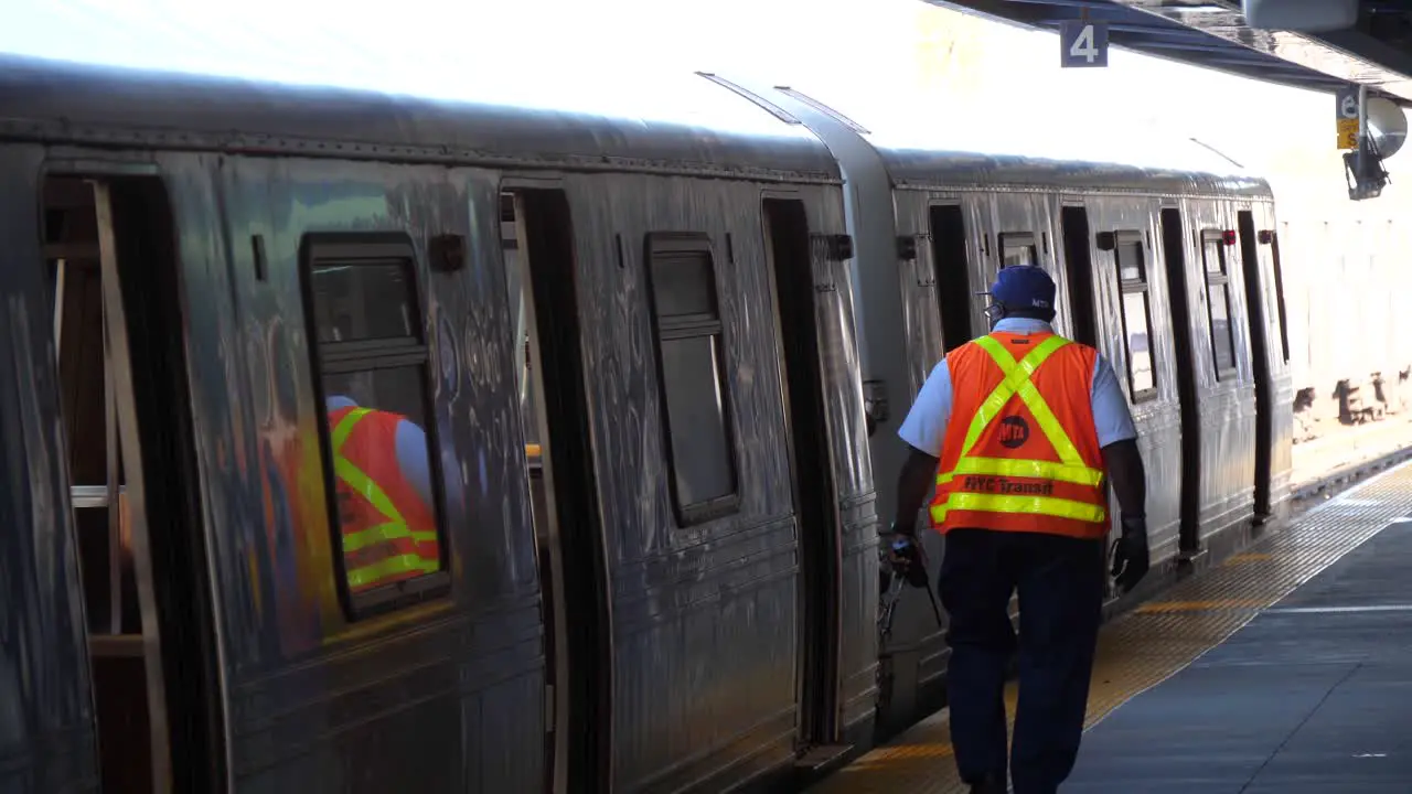 Man checking subway walking away from camera