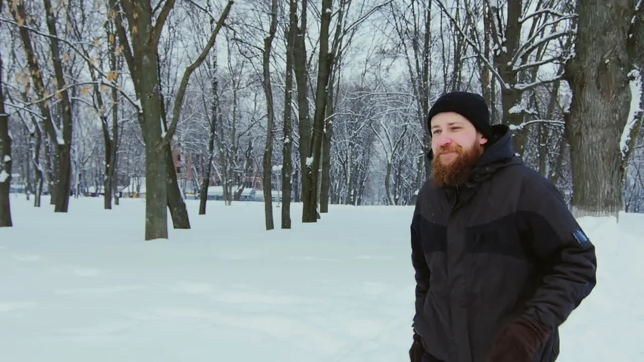 A Man Running In A Snow Covered Park