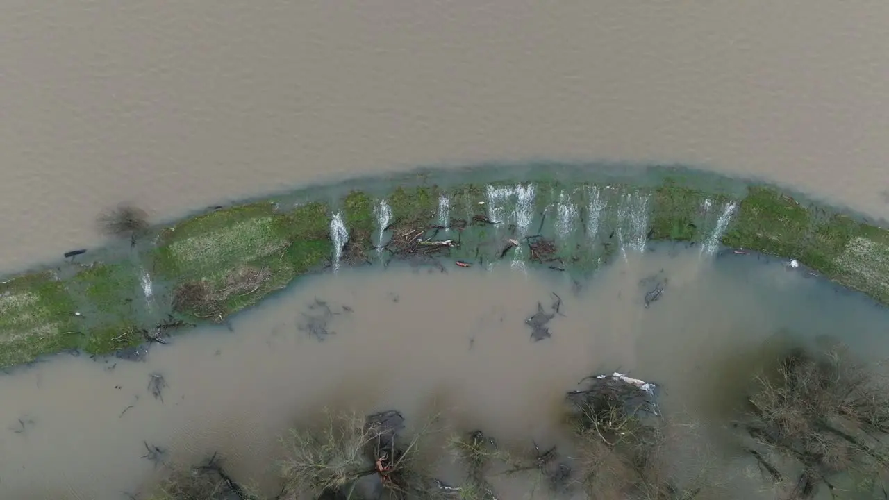 Water from river Waal flowing over banks flooding surrounding landscape