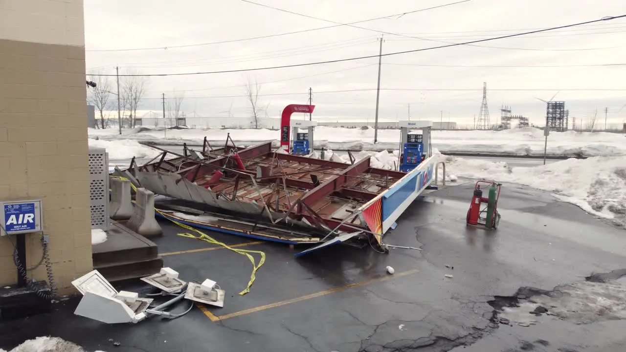 Drone view of roof on gas station torn off in extreme winter storm Dolly Shot