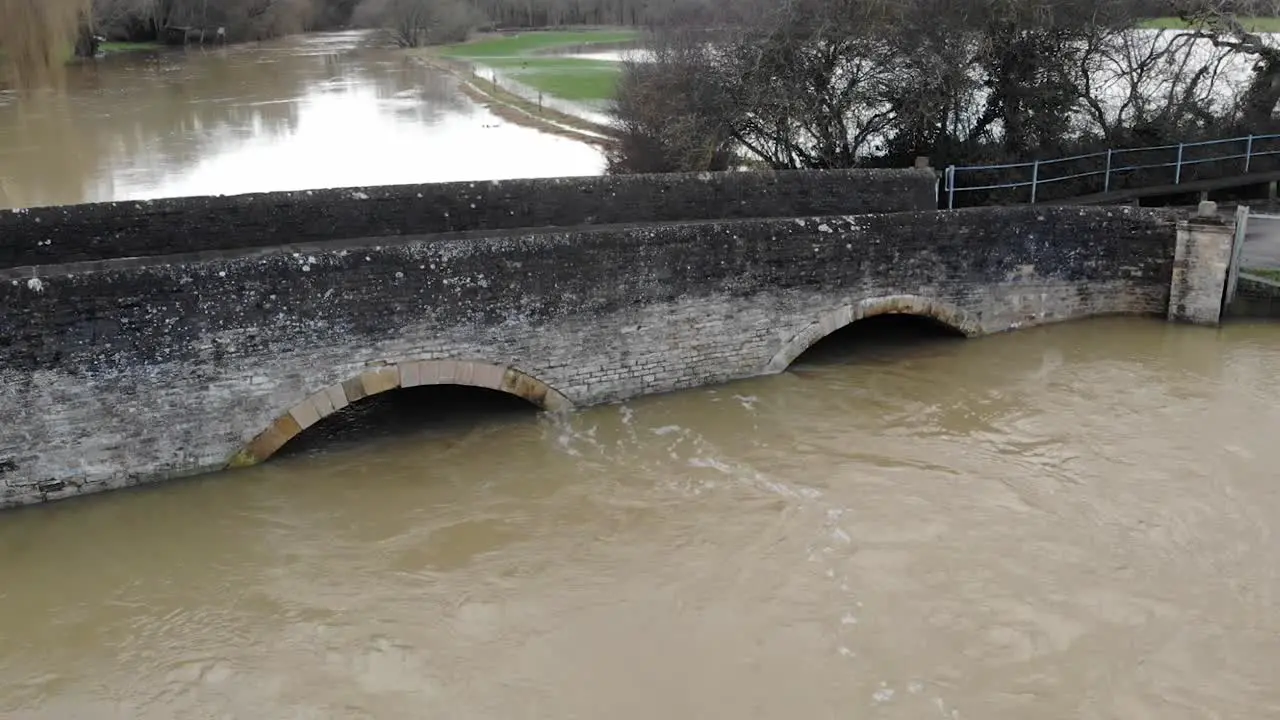 Flooded swollen river under bridge