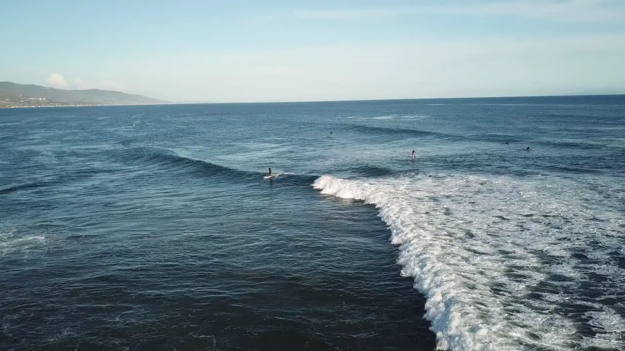 waves in Malibu beach with surfers