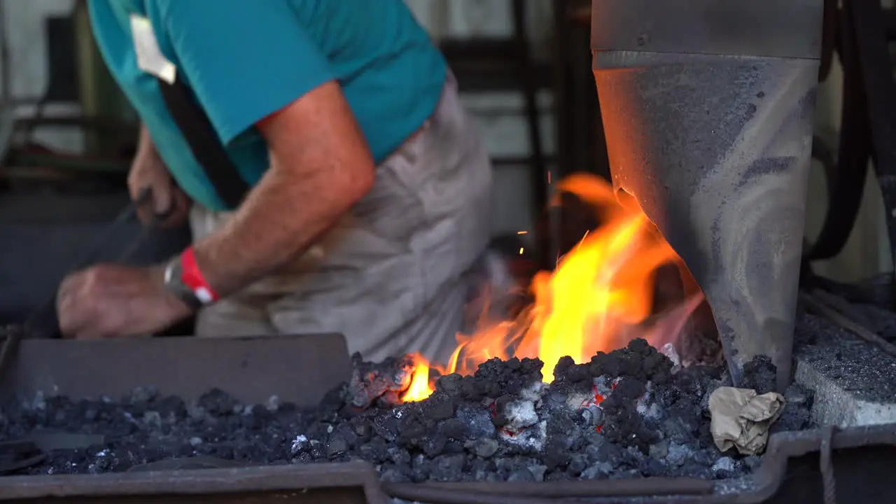 A small hot fire in a small forge heating up the metal