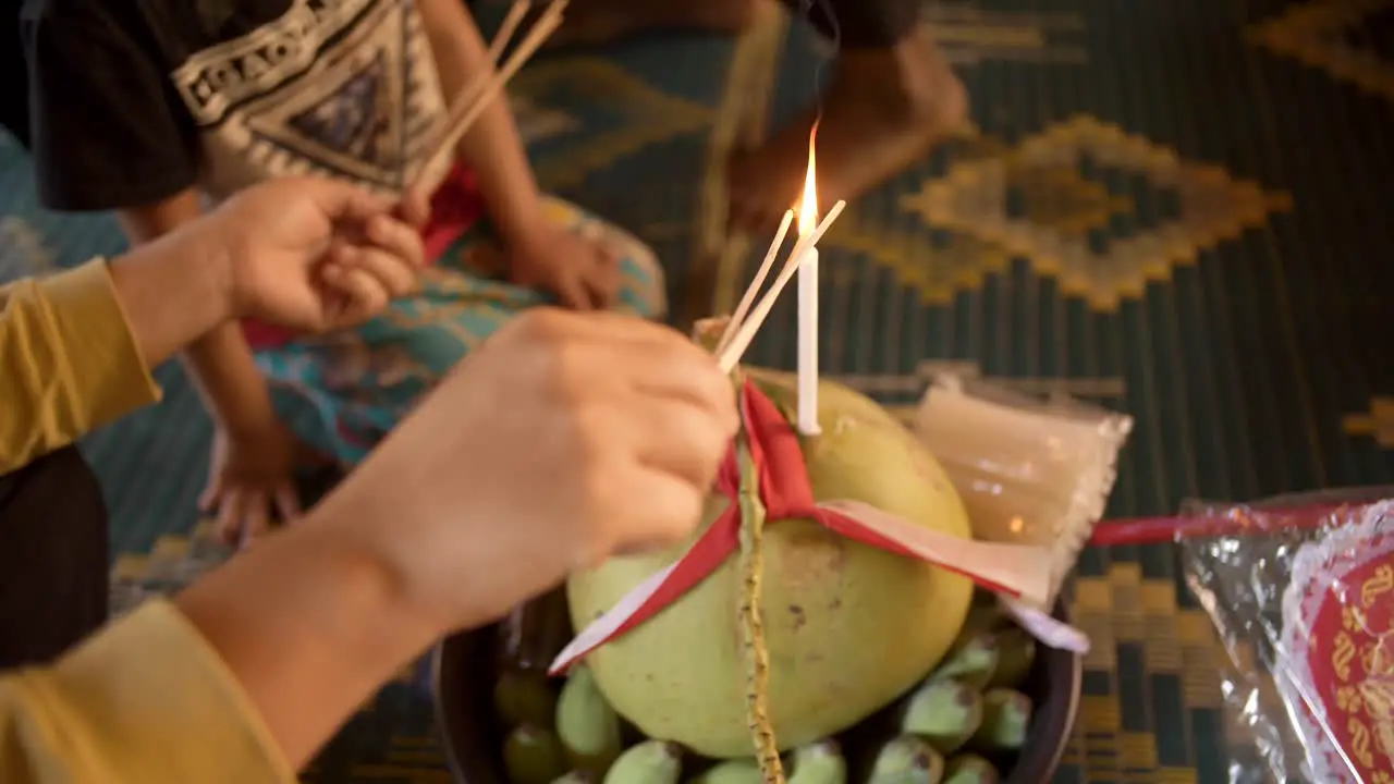 Asian Woman Lights Incense Spirit House Place Of Worship Near The Temple In Cambodia