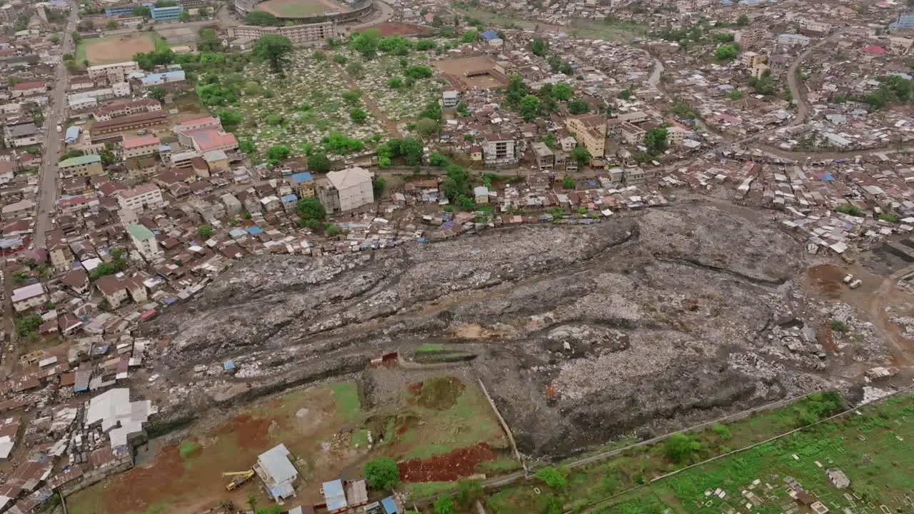 Slow aerial flyover of a landfill in Freetown in Sierra Leone