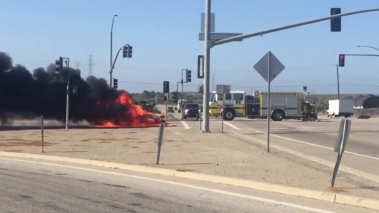 A car Kia Soul fire burns in an intersection with a fire truck nearby near Ventura California 1