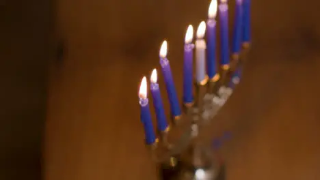 Extreme Close Up of Burning Candles On Menorah During Hanukkah 