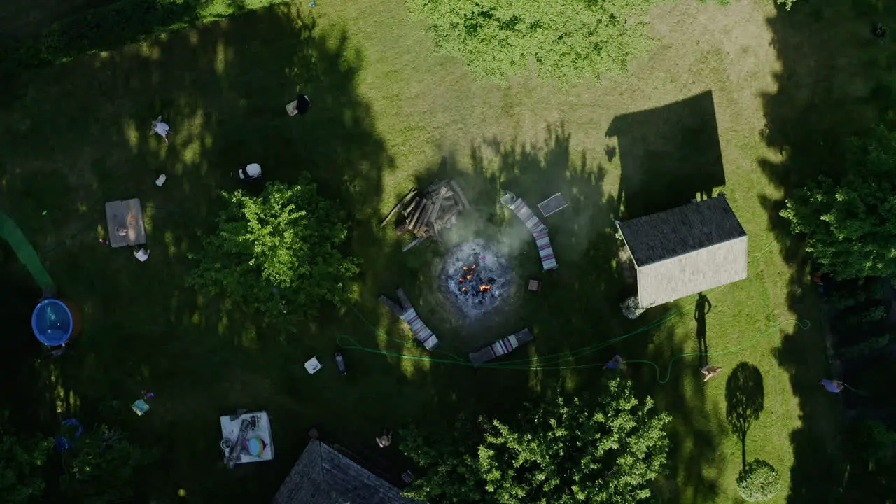 Top down bird's eye aerial view of bonfire in country house in summer