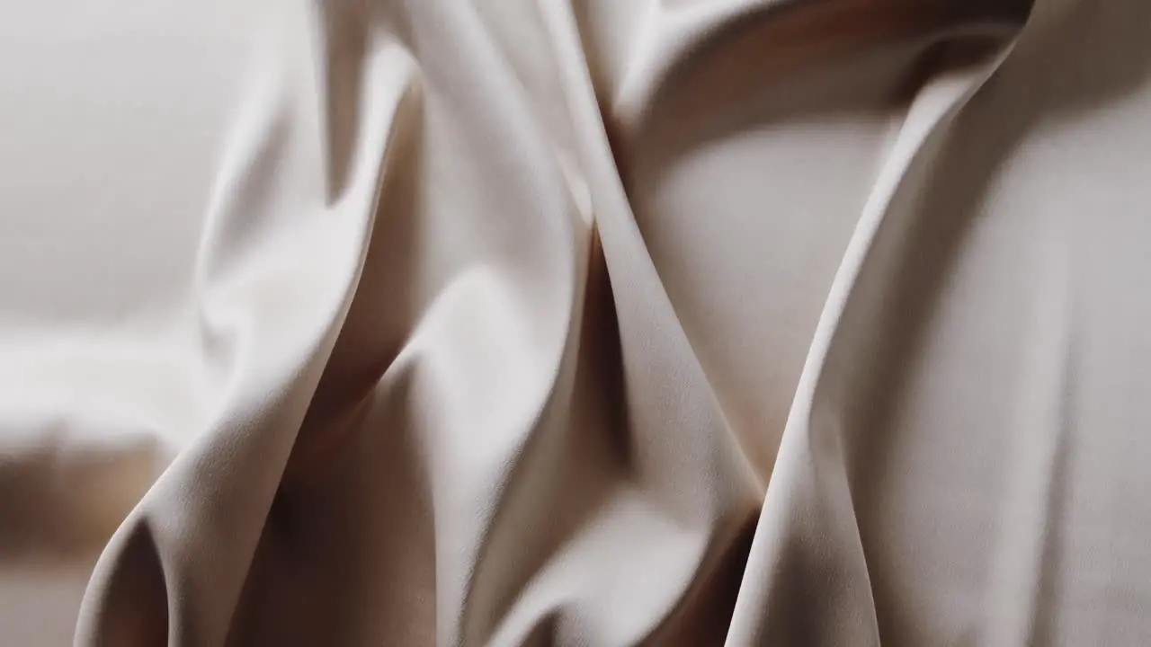 Close up of white shiny silk cloth in slow motion