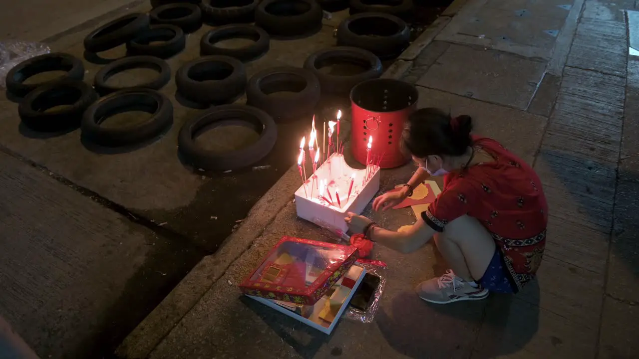 Residents burn paper money during the Hungry Ghost Festival