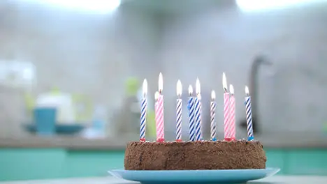 Birthday cake with candles flame on kitchen Birthday dessert with candles