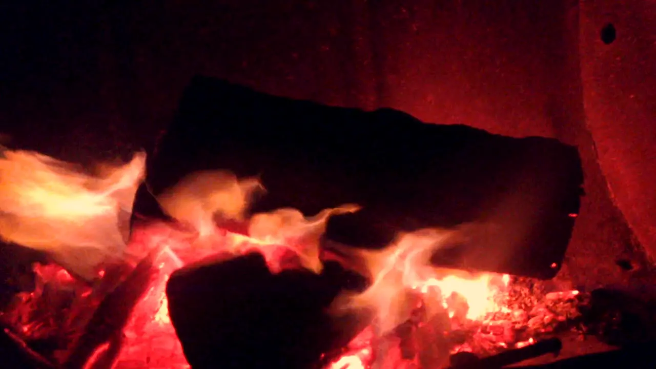 Fire blazing a campsite with warm red and yellow colours