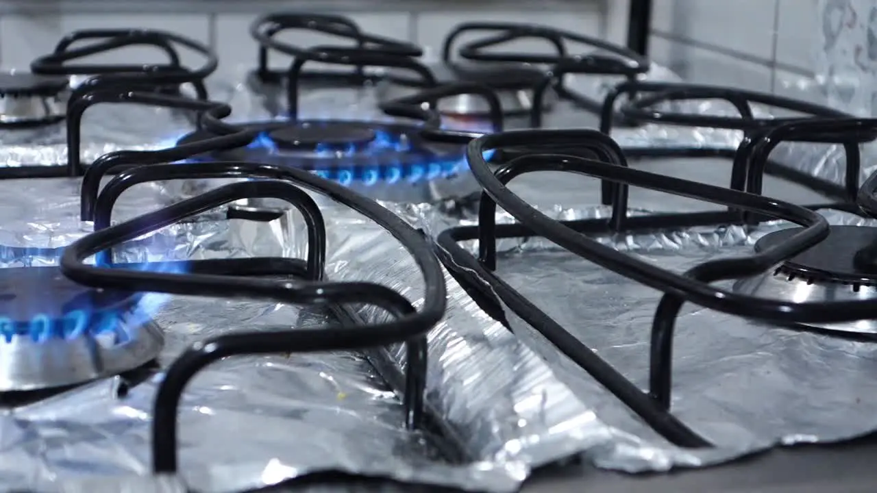 domestic kitchen burners turning on in sequence with blue flame