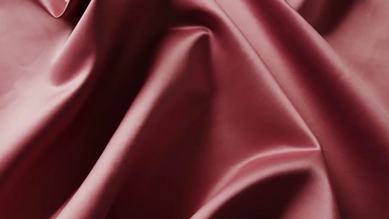 Close up of red shiny silk cloth in slow motion