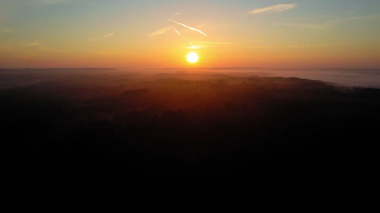 AERIAL Beautiful sunset over Veluwe National Park Netherlands rising shot