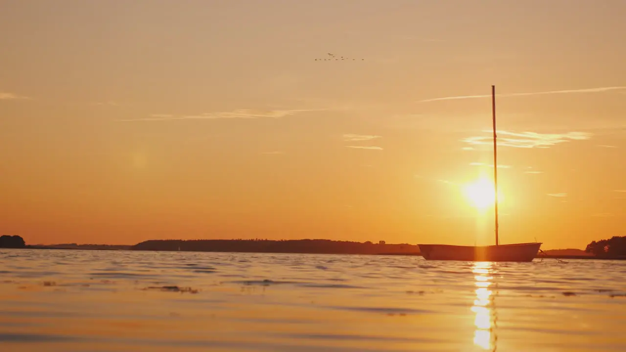 A Lonely Fishing Boat On The Mirror Surface Of The Lake The Setting Sun Illuminates Everything With 