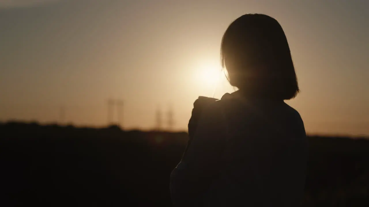 Woman drinking a cocktail at sunset