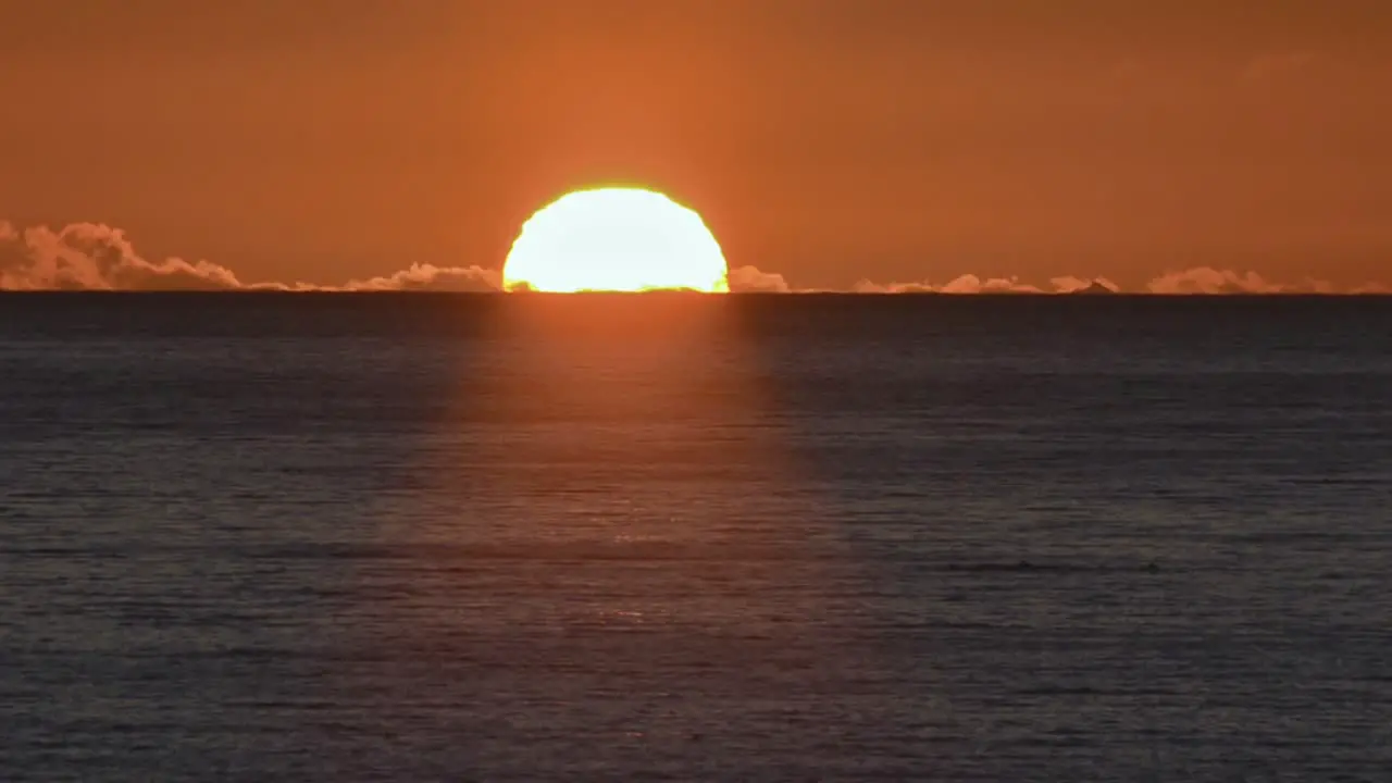 Telephoto of the midnight sun setting through clouds south of Ellesmere Island in Nunavut Canada