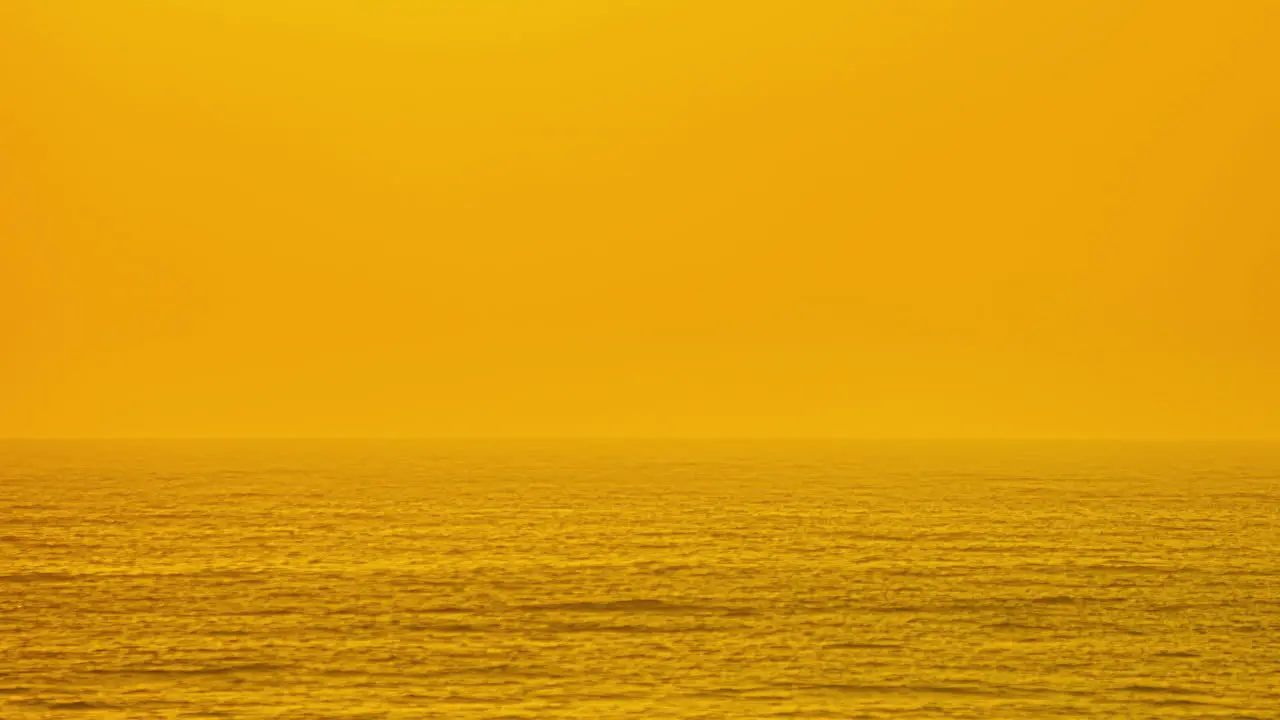 Golden Sunset Sky Over Foggy Seascape With Huge Sun Setting Down