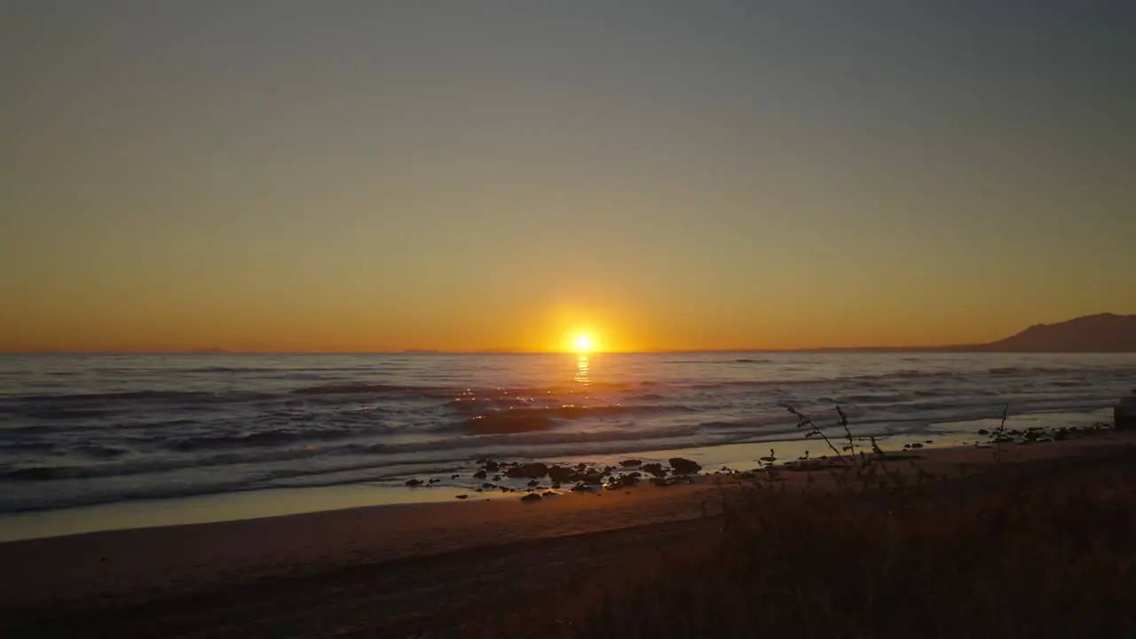 Empty beach at sunset with clear skies