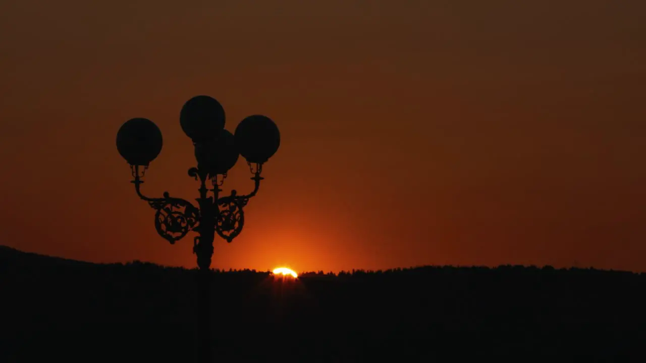 Silhouette Of A Lamp Post During Sunset With Orange Sky