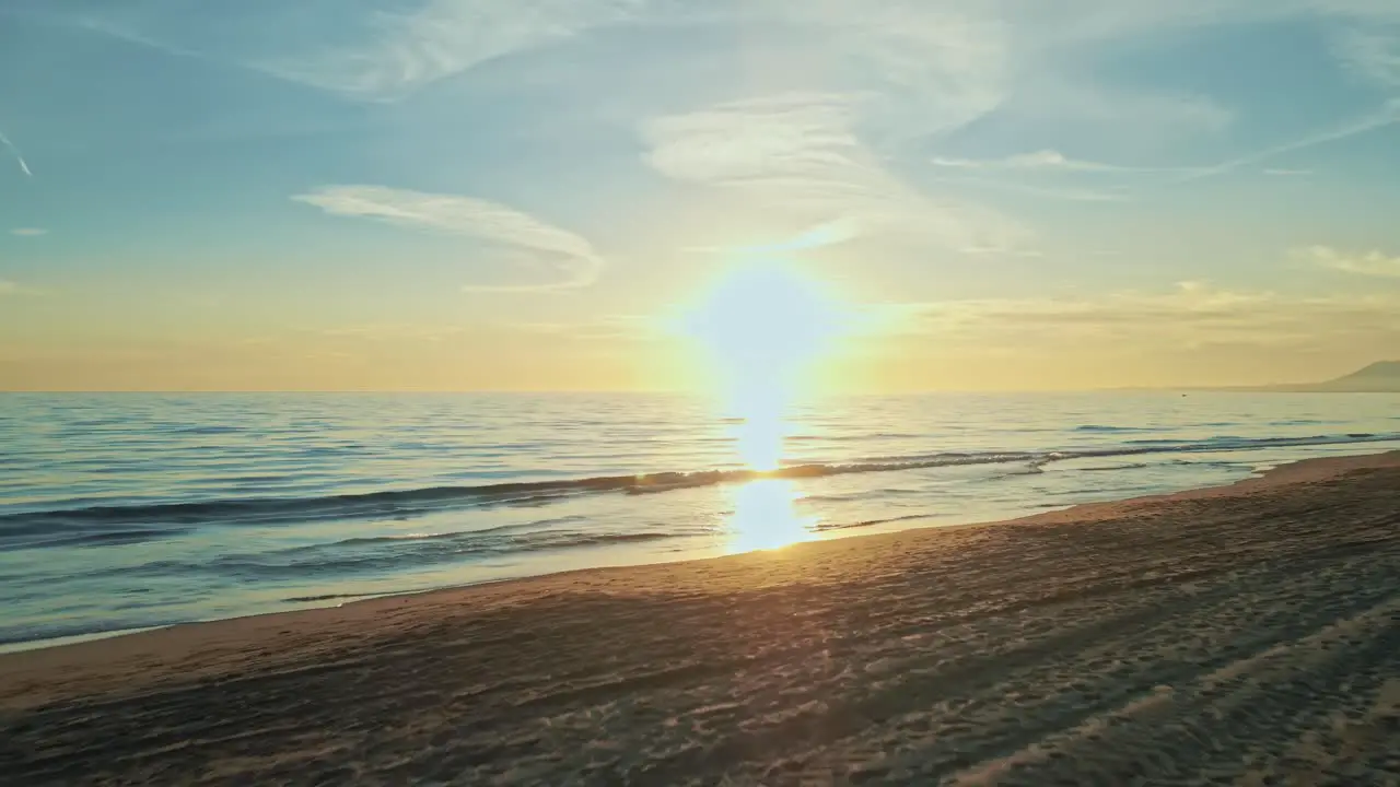 Drone flying into the sunset from a beach resort