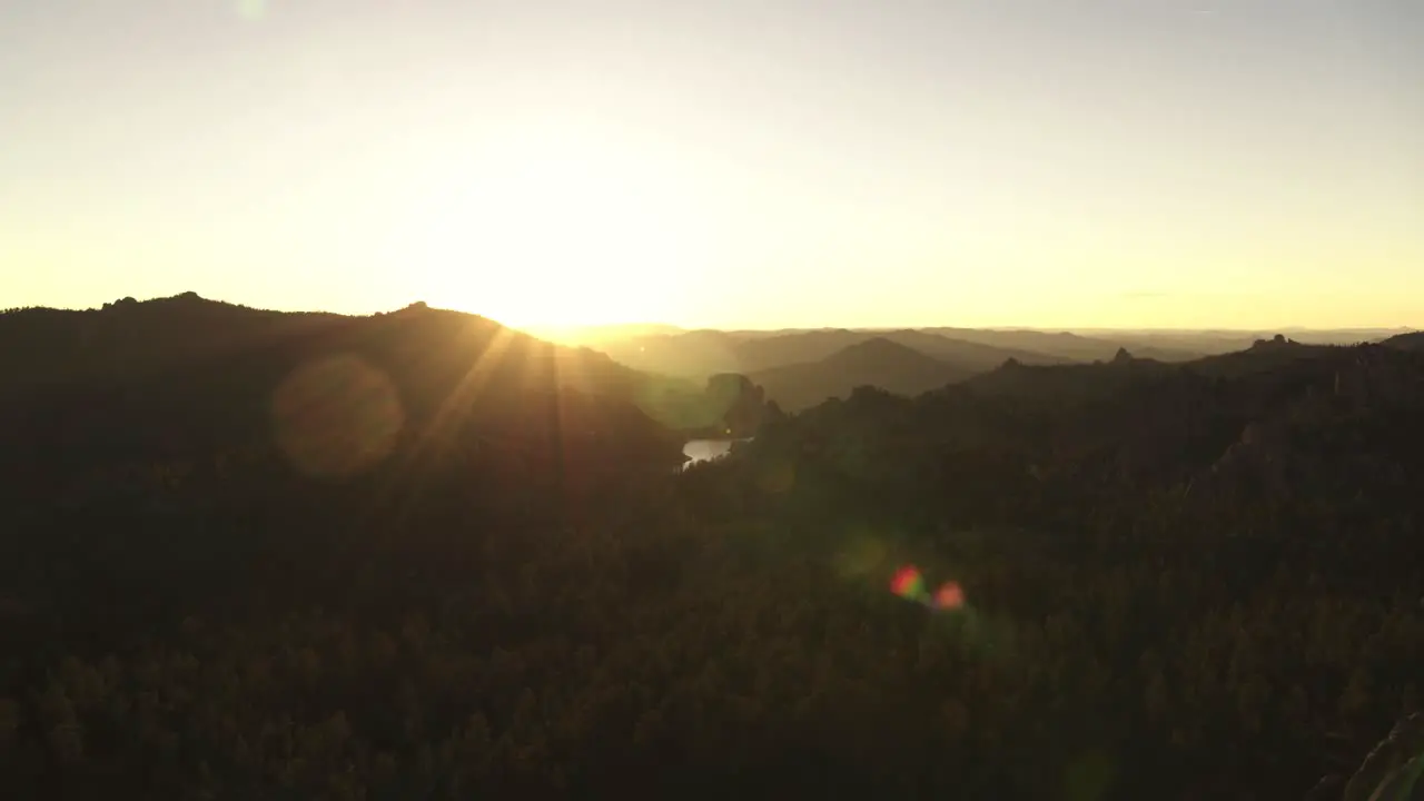 Dramatic aerial shot of river and hills in rural South Dakota with cinematic lens flare