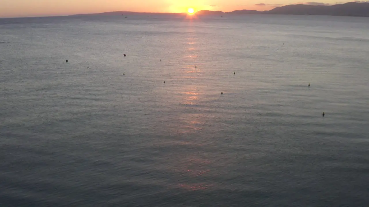 AERIAL Over Ocean with Waves into Sunset on Tropical Island Mallorca Spain on Sunny Day Vacation Travel Sunny