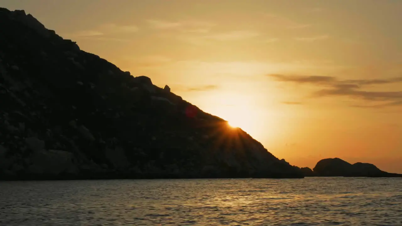 Dramatic and beautiful sunset on coast of Ibiza with silhouetted cliffs