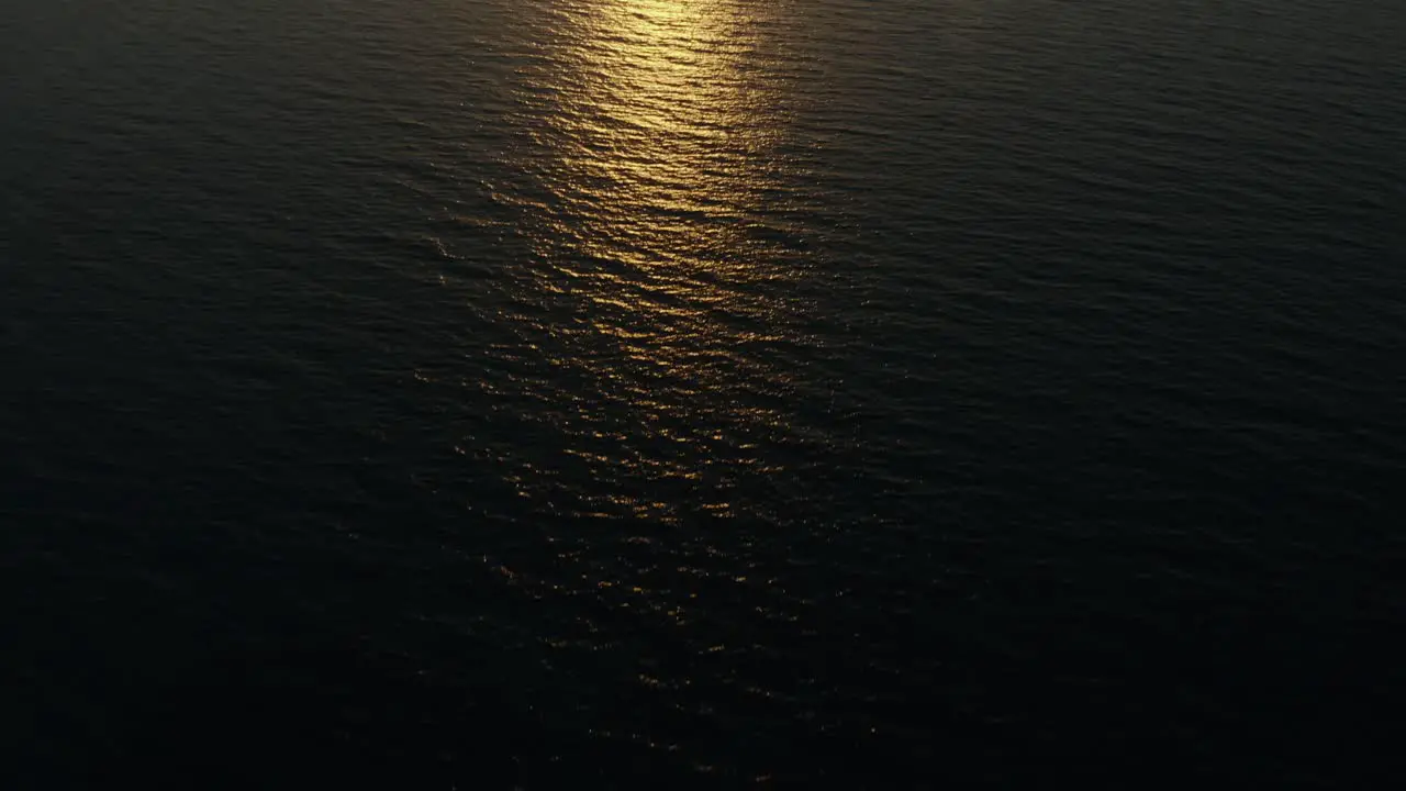 Aerial shot of the setting sun over the sea