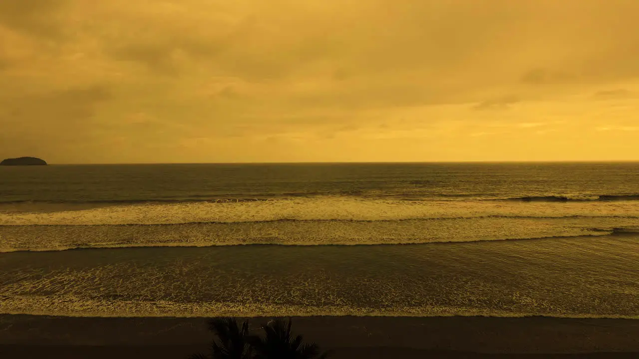 Drone shot from palm trees to a sunset in the beach