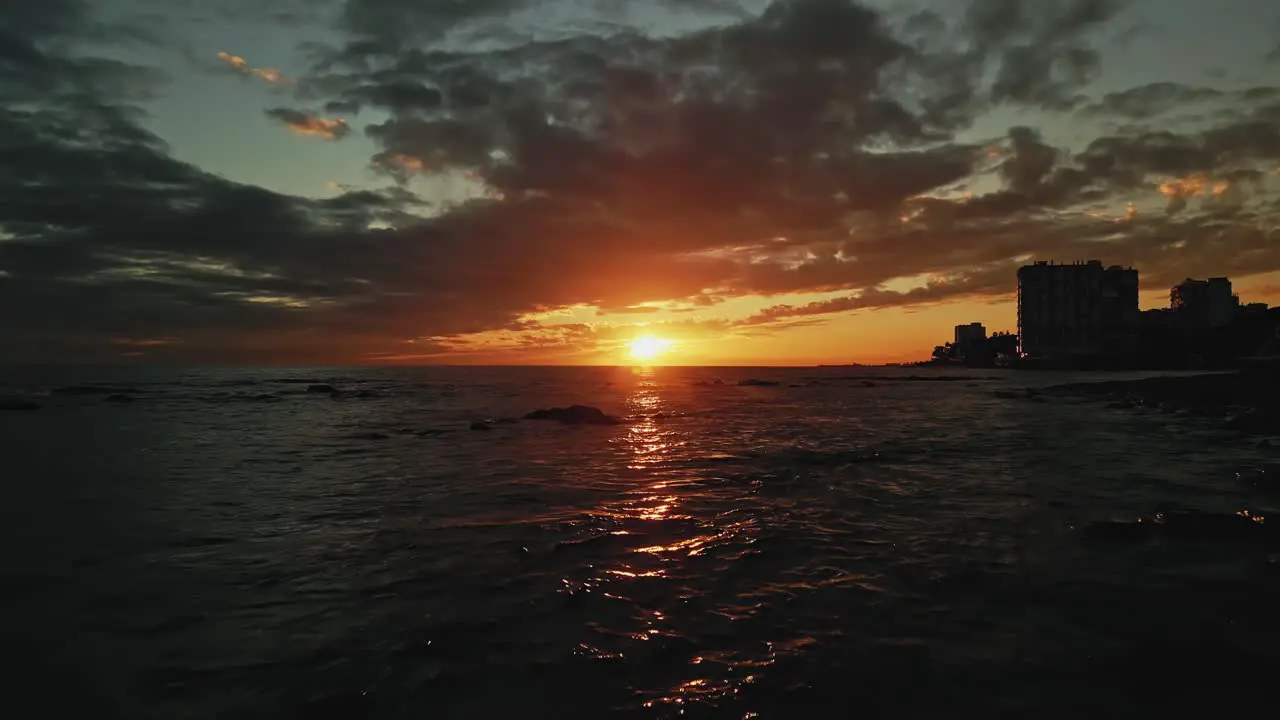 Dark aerial view of sunset or sunrise with dolly in over the sea