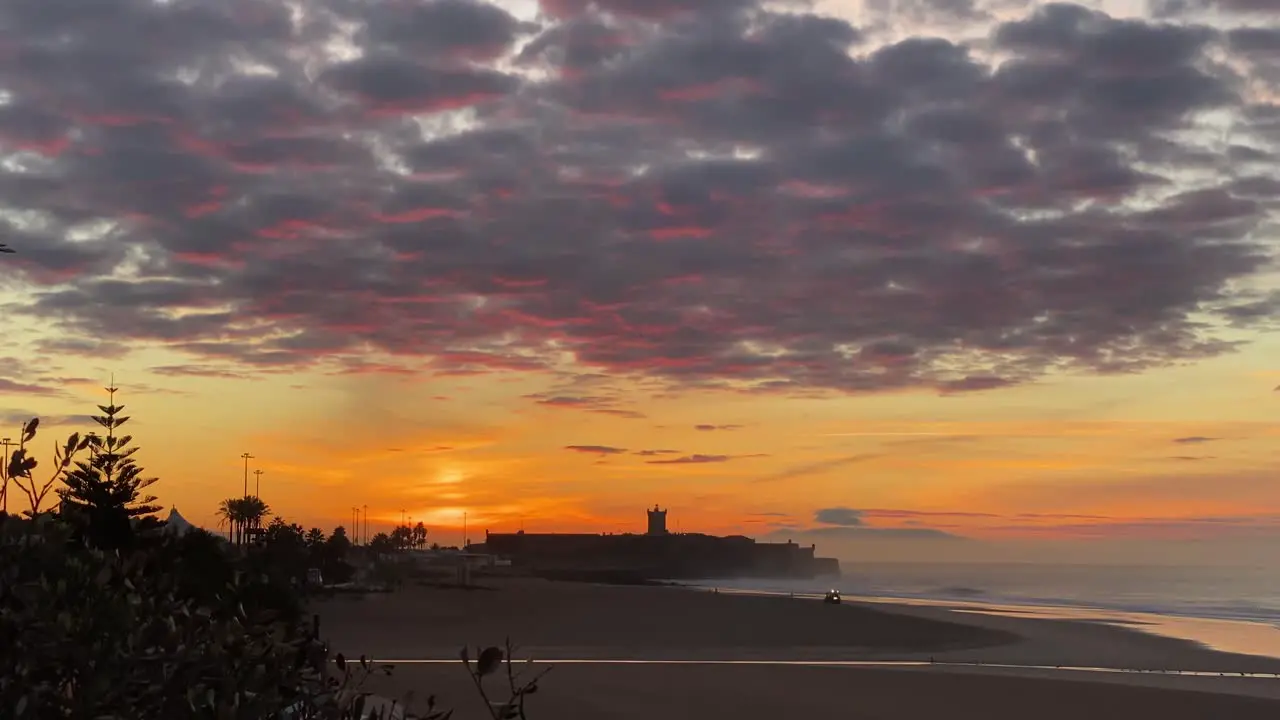 Aerial view over working tractor in Carcavelos beach sunrise in Portugal