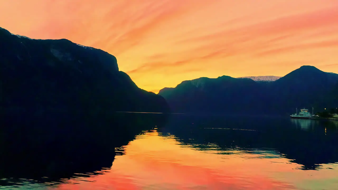 Scenic golden hour sunset with river and mountain landscape